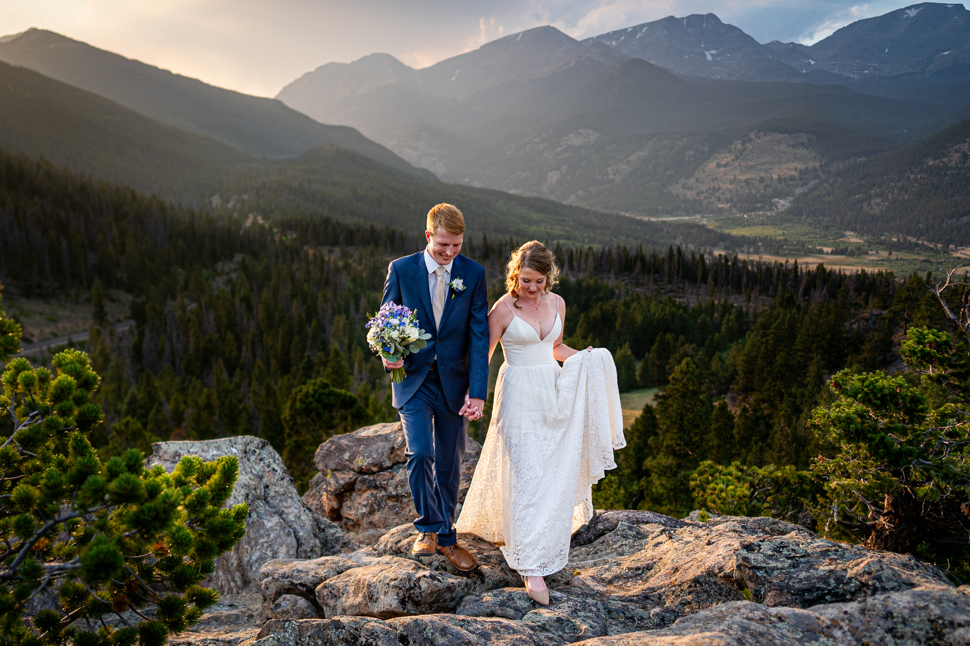 Bride & Groom walking up the Rockies of Colorado on their wedding day