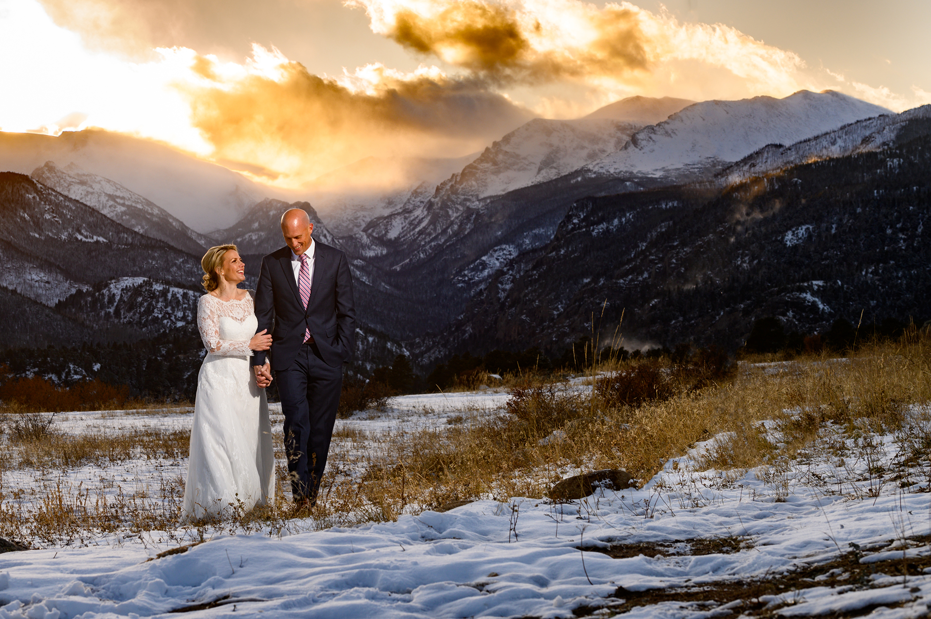 A wedding couple walking in the winter through Rocky Mountain National Park