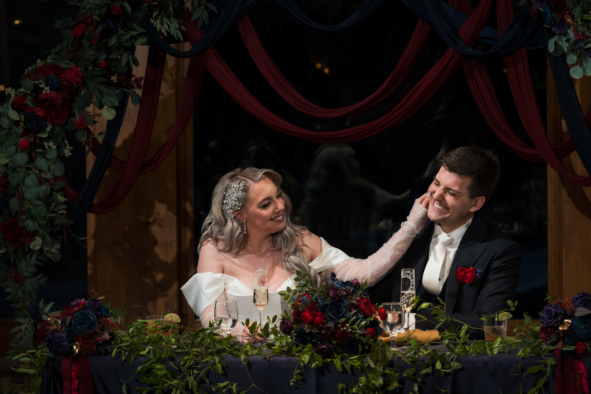 Bride pinching the groom's cheek during the toasts at a wedding in Estes Park, Colorado