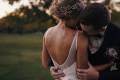 Groom kissing bride's shoulder on their wedding day
