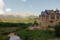 A wedding day couple at St. Malo's Church with Mt. Meeker in Allenspark, Colorado