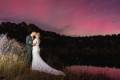 A wedding couple under an aurora in Rocky Mountain National Park, Colorado