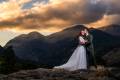 The bride catches a kiss from the groom on the top of the mountains of Rocky Mountain National Park