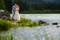Wedding couple holding each other by a lake in Rocky Mountain National Park, Colorado